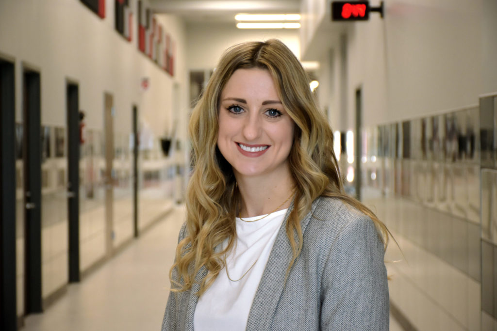 headshot of a person standing in a school hallway - link opens photo in full resolution